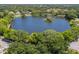 An aerial view showcasing the lake and surrounding community, highlighting the lush greenery and peaceful setting at 613 Sugarwood Dr, Venice, FL 34292