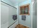 Bathroom featuring a glass-enclosed shower and towel racks next to window with shutter at 613 Sugarwood Dr, Venice, FL 34292