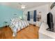 Comfortable bedroom features light blue accents, hardwood floors, and a bright, welcoming atmosphere at 613 Sugarwood Dr, Venice, FL 34292