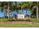 Chestnut Creek deed restricted community sign surrounded by lush green landscaping and mature palm trees at 613 Sugarwood Dr, Venice, FL 34292