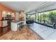 Open kitchen with stainless appliances opens up to the lanai through large sliding doors at 613 Sugarwood Dr, Venice, FL 34292