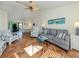 Inviting living room featuring terracotta tile, fan, beach decor, and seamless flow to outdoor space at 613 Sugarwood Dr, Venice, FL 34292