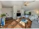 Inviting living room featuring terracotta tile, fan, beach decor, and seamless flow to outdoor space at 613 Sugarwood Dr, Venice, FL 34292