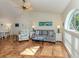 Bright living room with tile floors, vaulted ceiling with fan, and large window for plenty of natural light at 613 Sugarwood Dr, Venice, FL 34292