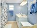 Bright bathroom with white vanity, tiled floors, and blue accents at 616 Circlewood Dr # S2-14, Venice, FL 34293