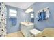 Bright bathroom with a single sink vanity, a white wicker chair and nautical themed decorations at 616 Circlewood Dr # S2-14, Venice, FL 34293