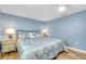 Bedroom features nautical decor, wood floors, a queen size bed, and ceiling fan at 616 Circlewood Dr # S2-14, Venice, FL 34293