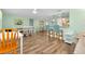 Open dining area with wood floors, a kitchen bar, and counter seating at 616 Circlewood Dr # S2-14, Venice, FL 34293
