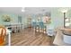 Open dining area with a kitchen bar, wood flooring, and counter seating at 616 Circlewood Dr # S2-14, Venice, FL 34293