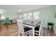 Bright dining area featuring wood floors, a dining table with six chairs, and modern décor at 616 Circlewood Dr # S2-14, Venice, FL 34293