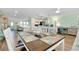 Open floor plan with a dining area flowing into the kitchen and living spaces at 616 Circlewood Dr # S2-14, Venice, FL 34293
