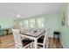 Dining area featuring wood floors, a table with six chairs, and bright natural light at 616 Circlewood Dr # S2-14, Venice, FL 34293