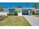 Charming single-story home featuring a screened-in porch, blue trim and well-maintained landscaping at 616 Circlewood Dr # S2-14, Venice, FL 34293