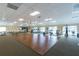Spacious gym featuring wood floors and exercise equipment with water views from large windows at 616 Circlewood Dr # S2-14, Venice, FL 34293