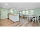 Open kitchen and dining area with wood floors and stainless steel appliances at 616 Circlewood Dr # S2-14, Venice, FL 34293