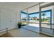 A view from the lanai shows the screened enclosure, tile floor and adjacent carport at 616 Circlewood Dr # S2-14, Venice, FL 34293