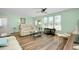 Bright living room with wood floors, white trim, and ample natural light from large windows at 616 Circlewood Dr # S2-14, Venice, FL 34293