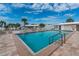 A large in-ground pool surrounded by lounge chairs creates a relaxing community space at 616 Circlewood Dr # S2-14, Venice, FL 34293