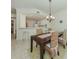 Dining room featuring a wooden table with wicker chairs and stylish chandelier at 632 Golf Dr # 632, Venice, FL 34285