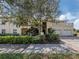 Charming two-story home featuring a two-car garage, balcony, and mature landscaping at 632 Golf Dr # 632, Venice, FL 34285