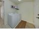 Functional laundry room with washer, dryer, and shelving for storage at 632 Golf Dr # 632, Venice, FL 34285