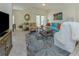 Well-lit living room featuring tile flooring, a cozy sofa, and elegant decor at 632 Golf Dr # 632, Venice, FL 34285