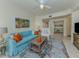 Bright living room with comfortable blue sofa, stylish rug, and decorative accents at 632 Golf Dr # 632, Venice, FL 34285