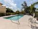 Relaxing outdoor pool area with lounge chairs and mature trees at 632 Golf Dr # 632, Venice, FL 34285
