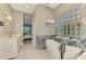 Bright bathroom with marble tile floors, free standing tub, and a glass block window for natural light at 647 Pond Willow Ln, Venice, FL 34292