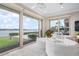 Main bedroom sitting area with water views and access to the outdoors at 704 Laguna Dr, Venice, FL 34285