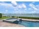 Relaxing view of a stunning pool and picturesque waterfront at 704 Laguna Dr, Venice, FL 34285