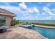 Beautiful backyard pool and spa overlooking tranquil blue water at 704 Laguna Dr, Venice, FL 34285