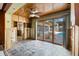 Living room with tiled floors, ceiling fan, sliding glass doors to the pool and outdoor living space at 715 Golden Beach Blvd, Venice, FL 34285