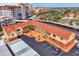 Aerial view showcasing the building's red tile roof and courtyard near other city buildings at 720 Apalachicola Rd # 104, Venice, FL 34285