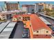 Aerial view of condo complex with covered parking, red roof, and nearby beach at 720 Apalachicola Rd # 104, Venice, FL 34285