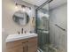 Inviting bathroom with a step-in shower featuring a glass door and a modern vanity at 720 Apalachicola Rd # 104, Venice, FL 34285