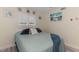 Bright bedroom featuring neutral walls, shuttered windows, and charming coastal decorations at 720 Apalachicola Rd # 104, Venice, FL 34285