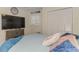Bright bedroom featuring a comfy bed, shuttered window, and large TV for relaxed viewing at 720 Apalachicola Rd # 104, Venice, FL 34285