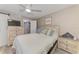Cozy bedroom with a ceiling fan, whitewashed furnishings, and a modern sliding barn door at 720 Apalachicola Rd # 104, Venice, FL 34285