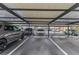 Covered parking area featuring assigned spots and ample space for residents and guests at 720 Apalachicola Rd # 104, Venice, FL 34285