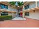 Charming courtyard with well-maintained landscaping and multiple palm trees at 720 Apalachicola Rd # 104, Venice, FL 34285