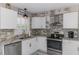 Bright kitchen featuring stainless steel appliances, white cabinets, and stylish stone countertops at 720 Apalachicola Rd # 104, Venice, FL 34285