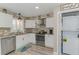 Updated kitchen with white cabinets, stainless steel appliances, and a convenient washer/dryer combo at 720 Apalachicola Rd # 104, Venice, FL 34285