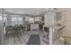 Well-lit kitchen with white cabinets, stone backsplash, stainless steel appliances, and dining area with a coastal design at 720 Apalachicola Rd # 104, Venice, FL 34285