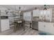 Kitchen area featuring wood accents, stainless steel appliances, and modern lighting at 720 Apalachicola Rd # 104, Venice, FL 34285