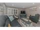 Cozy living room featuring stylish furniture, wood-style flooring, and coastal-themed decorations at 720 Apalachicola Rd # 104, Venice, FL 34285