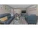 Inviting living room with modern coastal decor, wood-look floors, and comfortable seating at 720 Apalachicola Rd # 104, Venice, FL 34285