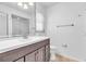 Well-lit bathroom features a modern vanity with a sleek countertop and a large mirror at 761 Vivienda South Ct # 14, Venice, FL 34293