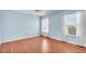 Bedroom featuring hard wood floors, light blue walls, and windows with natural light at 761 Vivienda South Ct # 14, Venice, FL 34293
