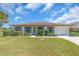 Charming single-story home with well-maintained lawn and landscaped front yard, offering great curb appeal at 761 Vivienda South Ct # 14, Venice, FL 34293